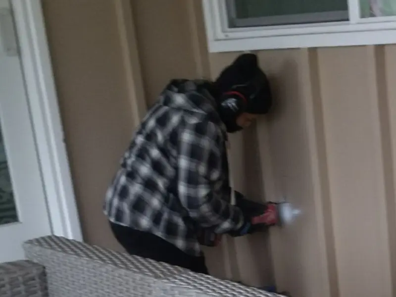 Professional electrician installing an exterior outlet in Hampden